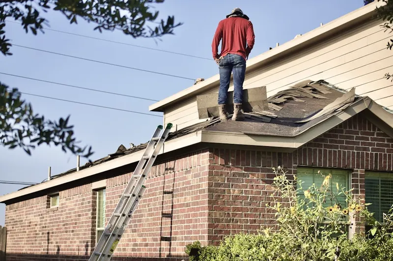 Professional roofer working on a residential roof in Anderwood Estates